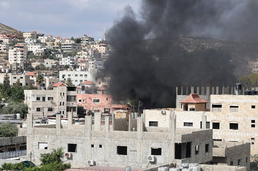 Smoke billows over the flashpoint West Bank city of Jenin as Israeli troops mount an incursion to arrest a wanted suspect, killing two Palestinians, according to the health ministry