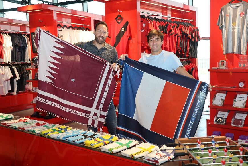 Bertrand Roine and Didier Grande are pictured with fan scarves they designed in the national colours of teams playing in the football World Cup