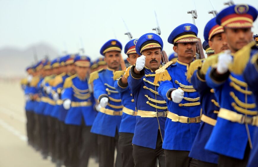 Fighters loyal to Yemen's Saudi-backed government take part in a military parade in the province of Marib