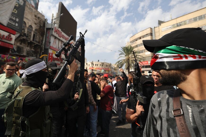 Efforts toward peace between Israel and the Palestinians have stalled for years. This picture shows Palestinian militants fire into the air during a funeral in Nablus in the occupied West Bank on October 23, 2022