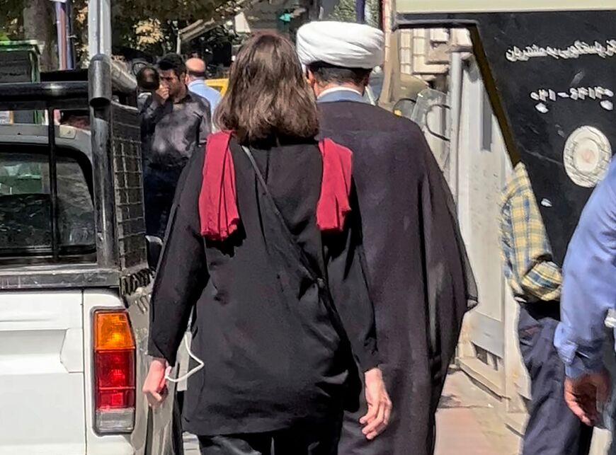 A picture obtained by AFP outside Iran shows a woman walking without a headscarf in downtown Tehran on October 11, 2022