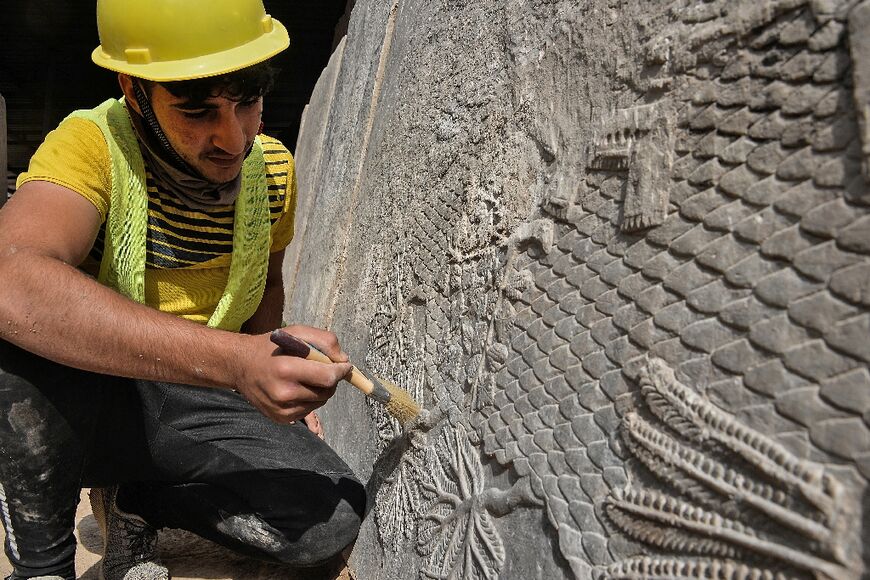 The 2,700-year-old carvings show a soldier in profile preparing to shoot an arrow from a bow, as well as finely chiseled palms