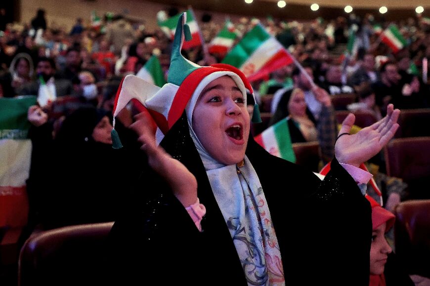 Men and women -- the latter wearing veils -- watched the game together in Milad Tower Hall in Tehran, in an unusual spectacle in a country where women have had difficulty accessing stadia