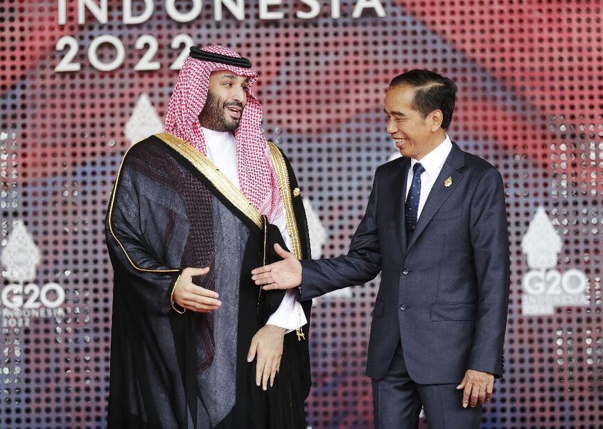 Saudi Arabia's crown prince Mohammed bin Salman (L) meets Indonesia's President Joko Widodo at the G20 leaders' summit in Bali, Indonesia