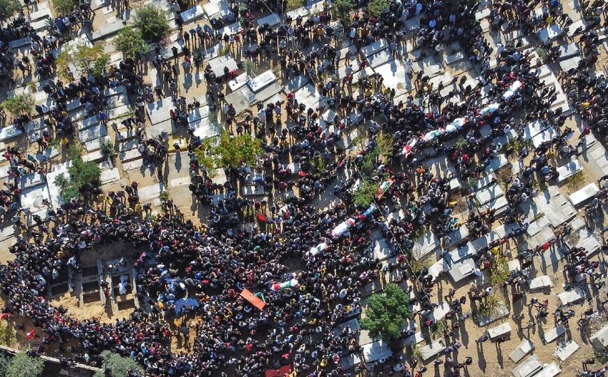 Mourners carried the coffins, draped in Palestinians flags, through crowds in the camp toward a cemetery for burial