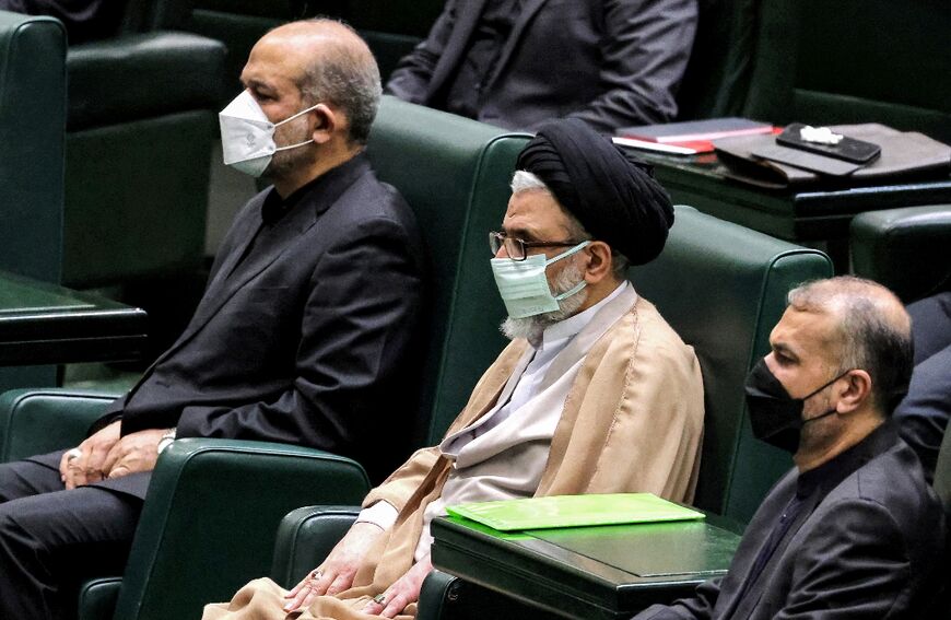 Esmail Khatib (C) and Hossein Amir-Abdollahian (R) attend a parliamentary session on August 21, 2021 that reviewed their nominations to Iran's cabinet