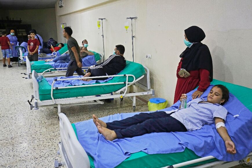 Patients receive treatment for Vibrio cholerae at a mosque hall converted into a field hospital in Bebnine, north Lebanon 