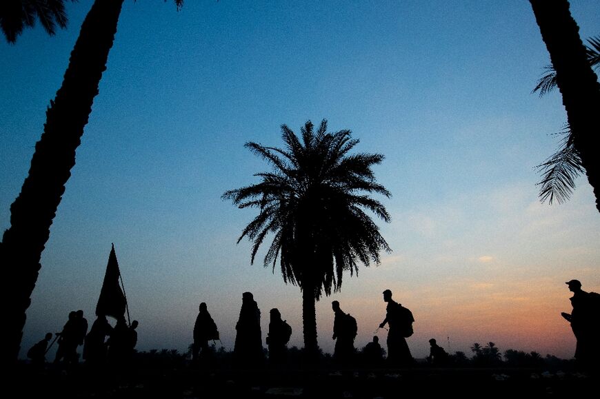 Shiite Muslim pilgrims march towards Iraq's holy city of Karbala to attend the Arbaeen religious commemoration, on September 13, 2022 near the city of Hilla