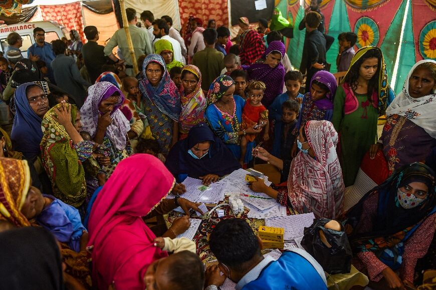 Pakistani internally displaced people at a medical camp in Sindh province -- worst-hit by the catastrophic flooding which put a third of Pakistan under water -- on September 27, 2022 