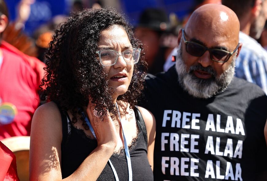 Hundreds marched behind Sanaa Seif (L)