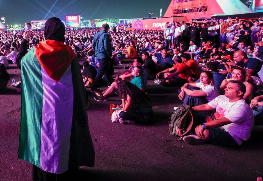 A fan wears a Palestinian flag during the Qatar 2022 World Cup Group D football match between France and Denmark at Stadium 974 in Doha, on November 26, 2022