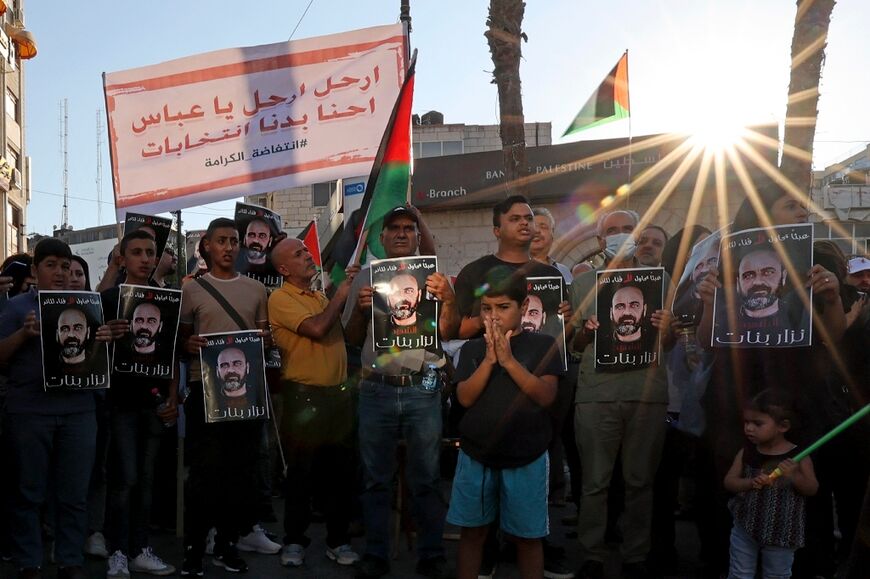 Palestinians in August 2021 in Ramallah in the occupied West Bank hold portraits of activist Nizar Banat, who died in custody in June 2021