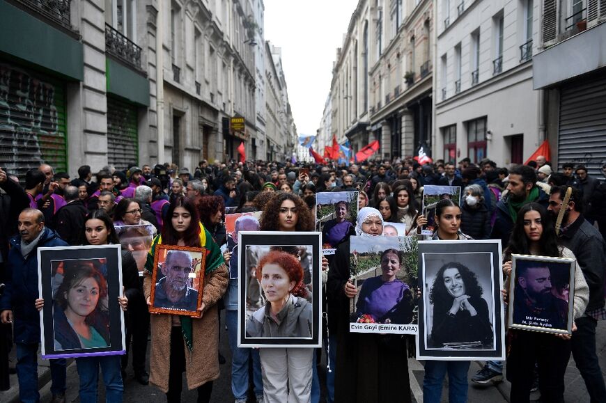 Several hundred people marched in Paris on Monday to remember the shooting victims. 