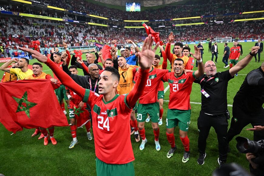 Morocco players celebrate with their supporters after they became the first African nation to reach the World Cup semi-finals