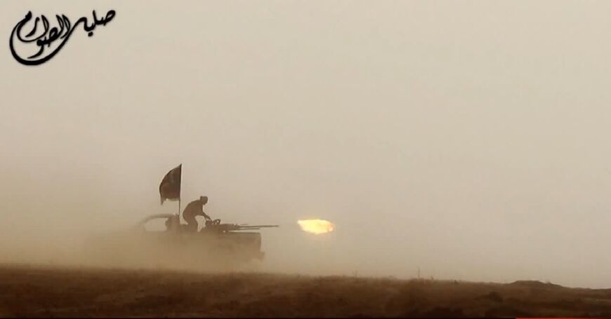 An image grab taken from an IS propaganda video uploaded on June 8, 2014 allegedly shows their militants firing from the back of a vehicle near the central Iraqi city of Tikrit