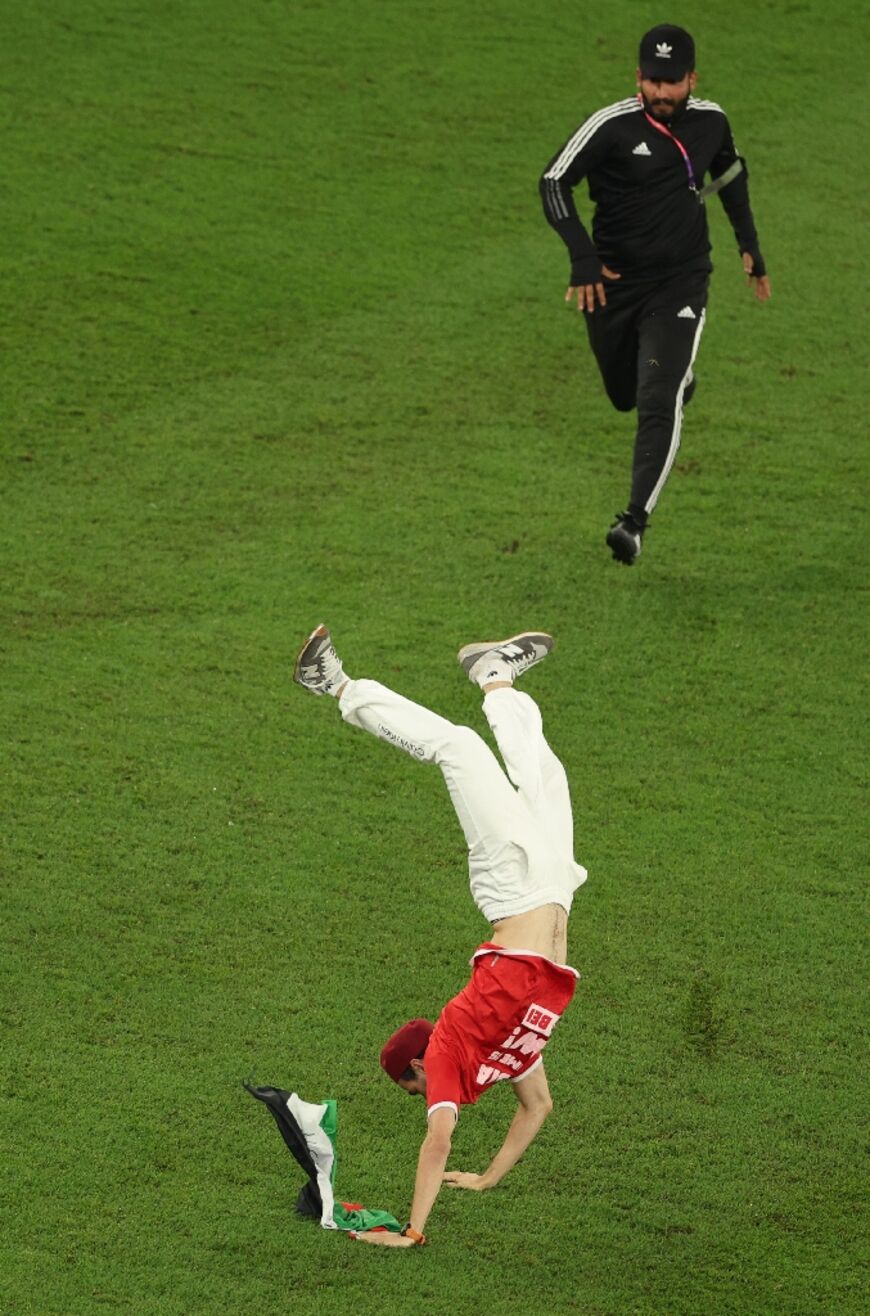 A pitch invader with a Palestinian flag seen during the Qatar 2022 World Cup Group D football match between Tunisia and France on November 30, 2022