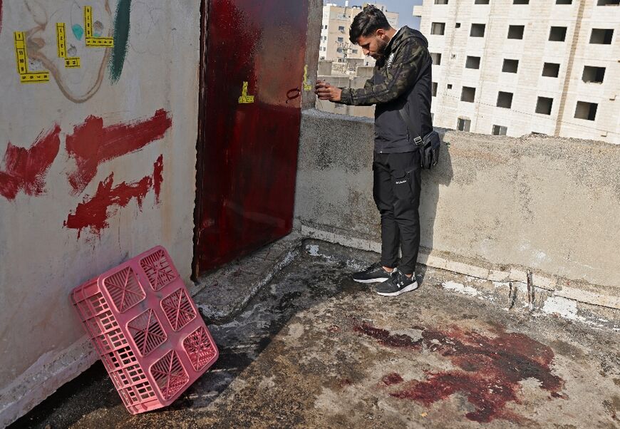 A Palestinian inspects the area where a teenage girl was killed during an Israeli raid in Jenin city in the occupied West Bank