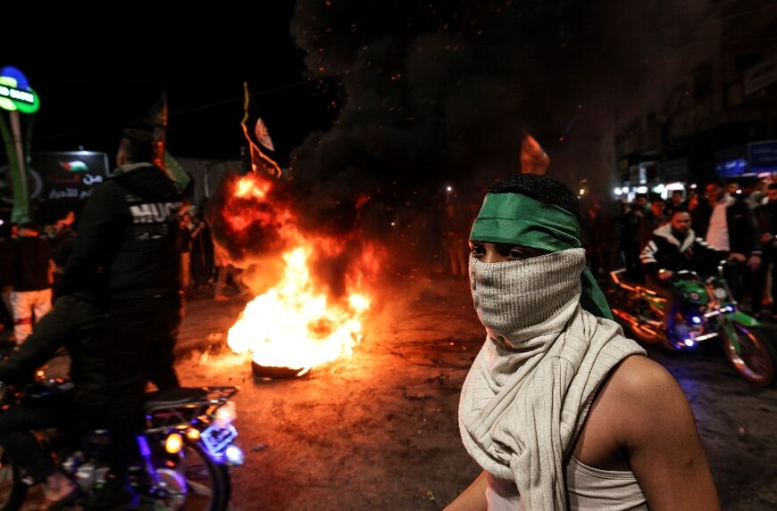 Palestinians celebrate in Gaza City following a shooting attack by a Palestinian gunman outside an east Jerusalem synagogue