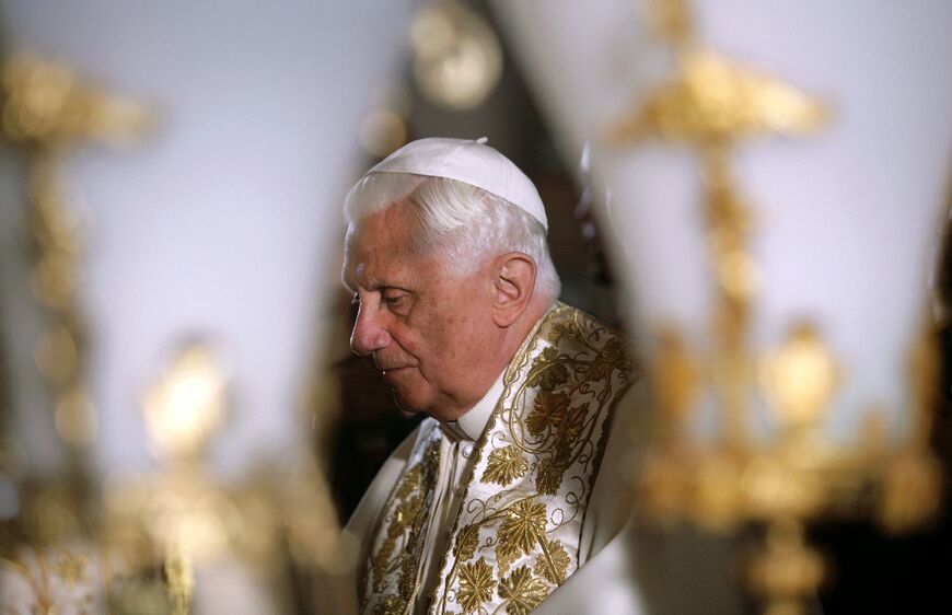 Former pope Benedict XVI, who has died at the age of 95, pictured on May 15, 2009, in front of the Stone of Anointing at the Church of the Holy Sepulchre in Jerusalem's Old City