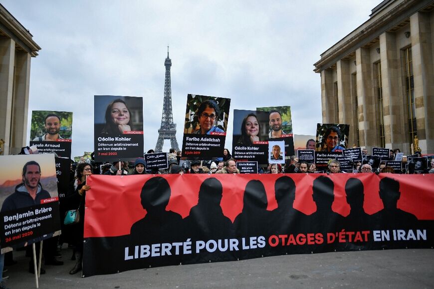 Dozens of people gathered behind a banner calling for 'freedom for the hostages in Iran'