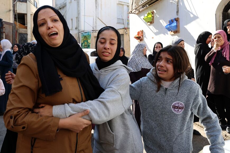 Relatives at the funeral of Palestinians killed during an Israeli raid on the Jenin refugee camp in the occupied West Bank on January 26, 2023 that the army labelled a 'counterterrorism operation'