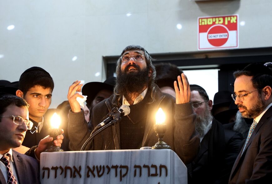 Aharon Natan, father of 14-year-old Asher Natan who was killed in Friday's attack, mourns during his funeral in Jerusalem