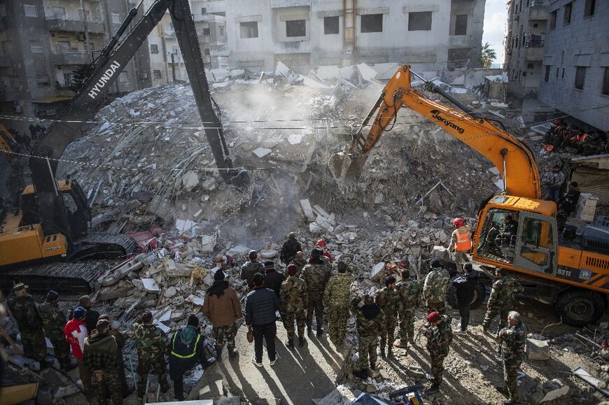 Rescue workers search for survivors in the town of Jableh in northwestern Syria