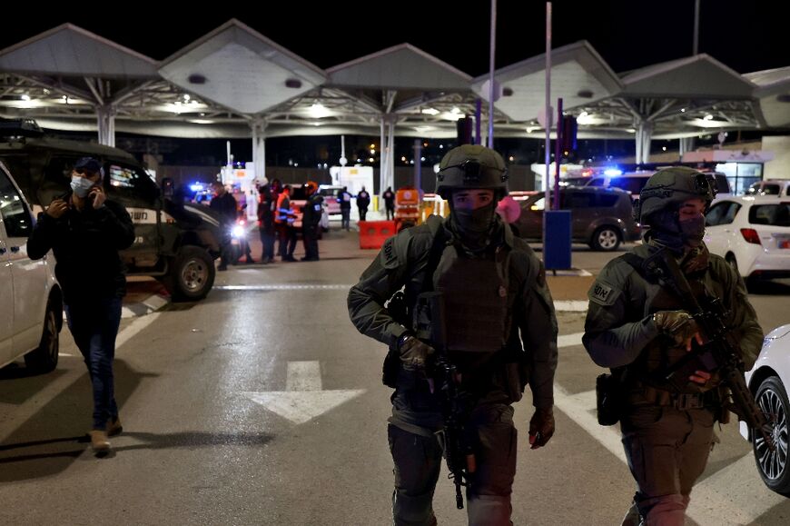 Israeli security forces gather at the entrance to east Jerusalem's Shuafat refugee camp following a stabbing attack on February 13