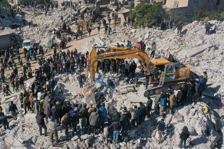 Rescuers search amid the ruins in Syria's rebel-held northwestern Idlib province on February 8, 2023 