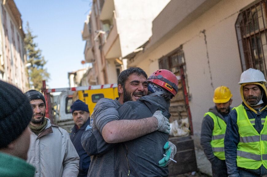 A miner reacts after rescuing a 16-year-old girl who was stuck for three days in Hatay