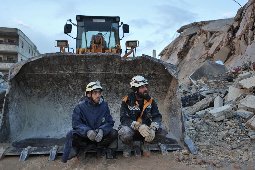 First responders from the White Helmets group sit on an excavator in the town of Sarmada, in Syria's rebel-held northwest