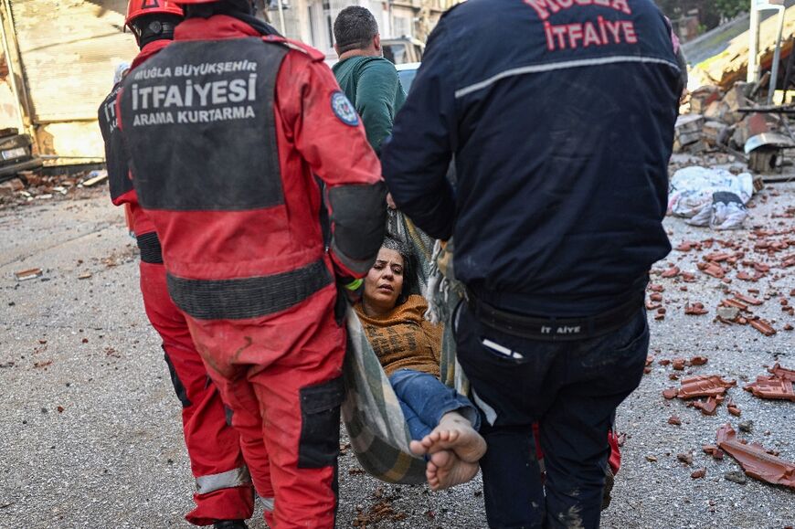 A woman is rescued after surviving the earthquake in the hard-hit Hatay province in Turkey 