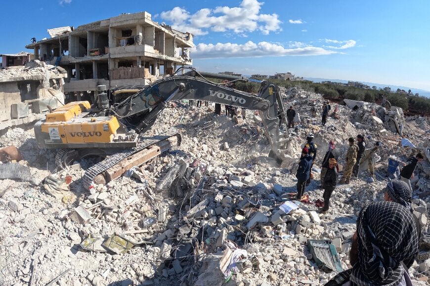 Rescue workers look for survivors in the rebel-held town of Jindayris in Syria