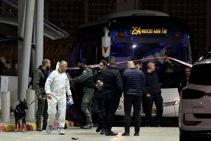 Israeli security forces gather at a checkpoint at the entrance to east Jerusalem's Shuafat refugee camp following a stabbing attack on February 13, 2023