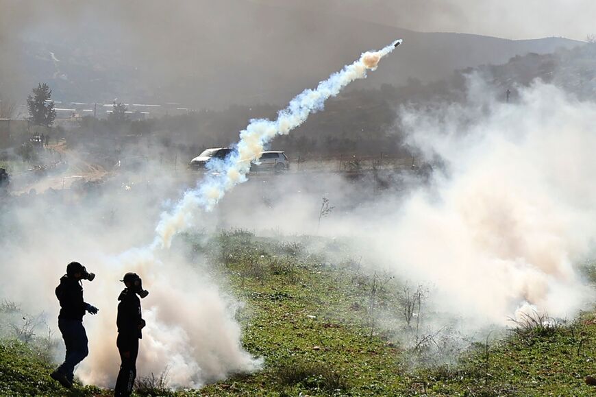 Palestinian demonstrators clash with Israeli soldiers following a protest against the establishment of Israeli outposts, in Beit Dajan, east of the occupied West Bank city of Nablus, on February 10, 2023