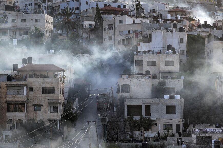 Israeli army vehicles move along a road during a raid in the Jenin camp for Palestinian refugees in the occupied West Bank