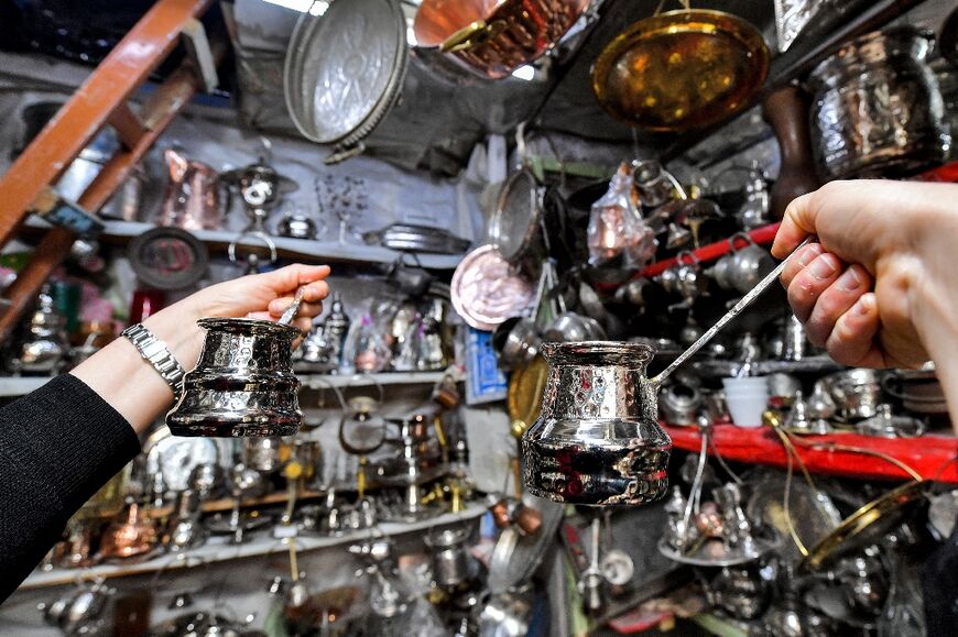 Customers inspect their freshly-polished cookware just ahead of the Muslim holy fasting month of Ramadan