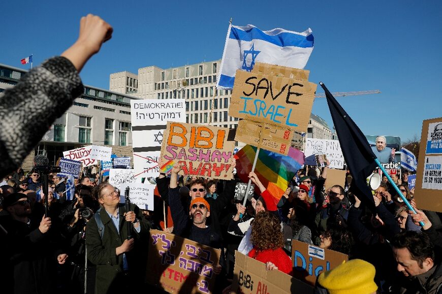 Demonstrators protest in front of the Brandenburg Gate in Berlin against Netanyahu's coalition's planned judicial reforms