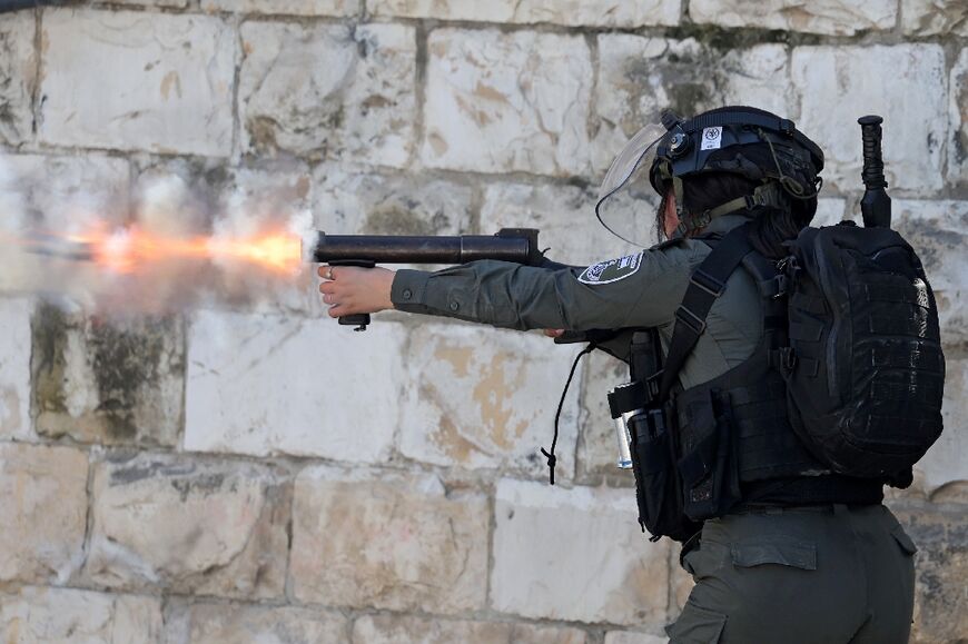 A member of the Israeli security forces uses tear gas to disperse Palestinians demonstrating against the demolition of houses by Israeli authorities in the Arab neighbourhood of Silwan in Israeli-annexed east Jerusalem, on March 3, 2023