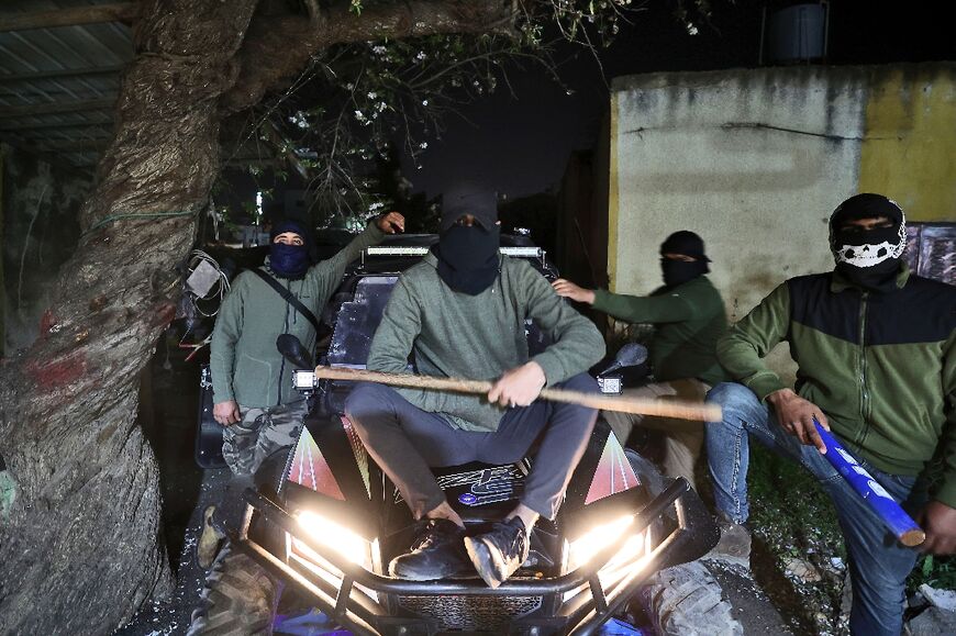 The masked Palestinian volunteers patrol village lands on off-road buggies or on foot