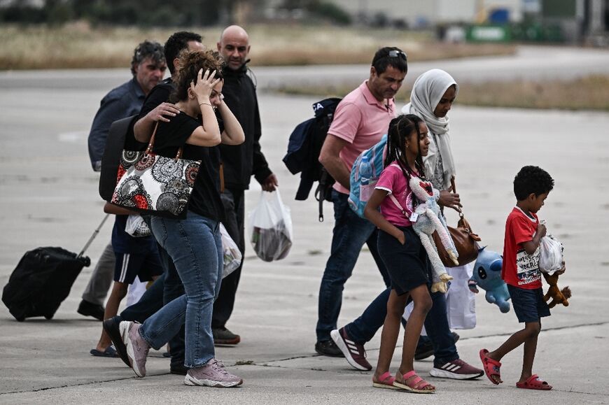 Greek nationals from Sudan arrive with a military C-27 plane at the military airport of Elefsina, south of Athens, on April 25, 2023