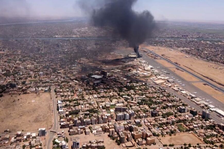 This image grab taken from AFPTV video footage on April 20, 2023, shows an aerial view of black smoke rising above the Khartoum International Airport amid ongoing battles 