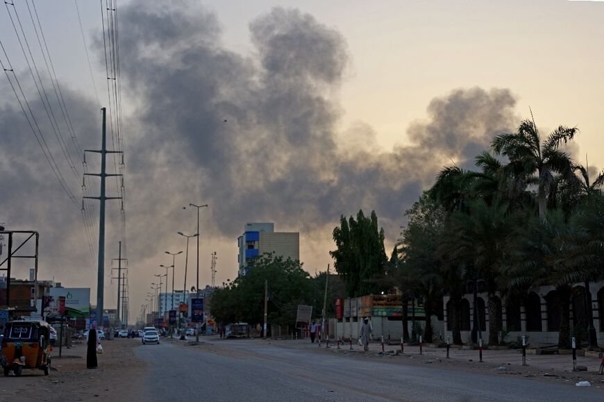 Smoke billows above residential buildings in east Khartoum as fighting in Sudan raged for a second day