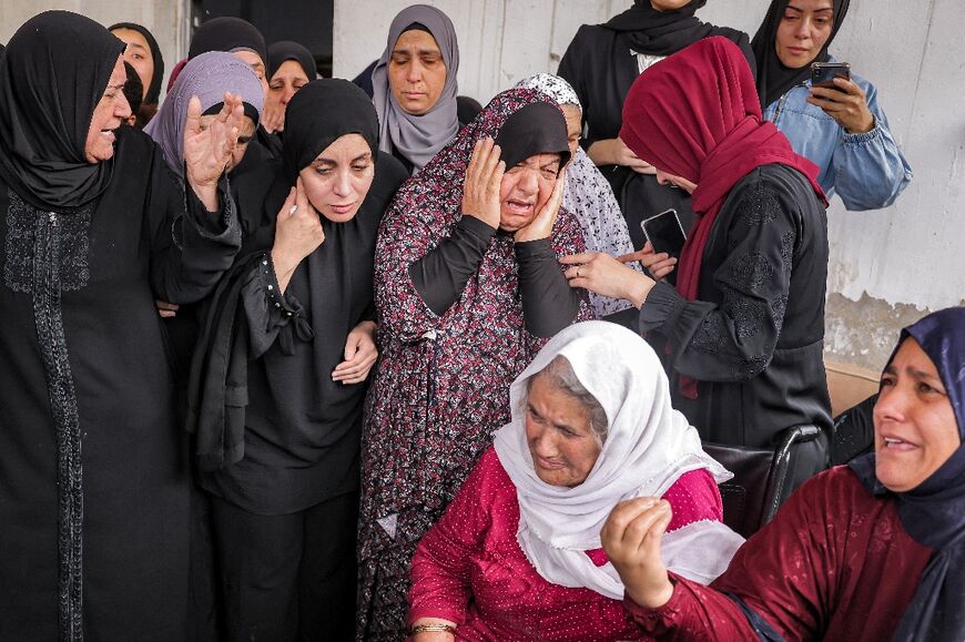 Palestinian mourners at the funeral of a 15-year-old boy who was shot dead by Israeli forces   