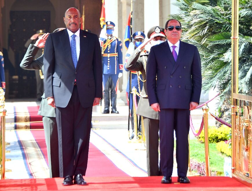 Sudan's army chief General Abdel Fattah al-Burhan on a visit with Egyptian President Abdel Fattah al-Sisi (R) in Cairo, March 30, 2022