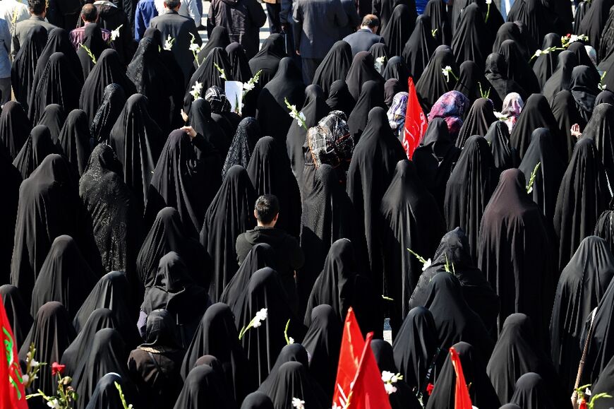 Mourners attend the funeral procession for two of Iran's revolutionary guard forces killed by Israel in Syria, held in Tehran on April 4, 2023