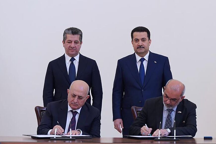 Iraqi Prime Minister Mohammed Shia al-Sudani, standing on the right, and his Kurdish counterpart Masrour Barzani attend the signing of the agreement 