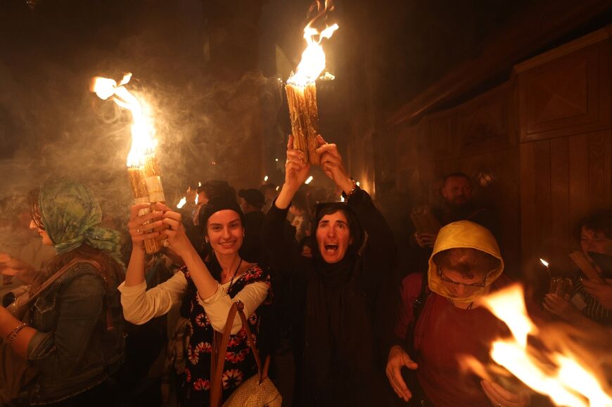 Orthodox Christians inside the Church of the Holy Sepulchre in Jerusalem after the Holy Fire ceremony