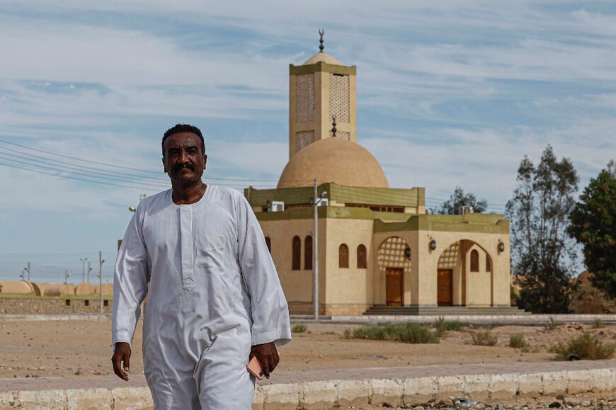 Sudanese evacuee Walid Soliman walks to the residence where he and his family are hosted, at an Egyptian family's home in Wadi Karkar village 