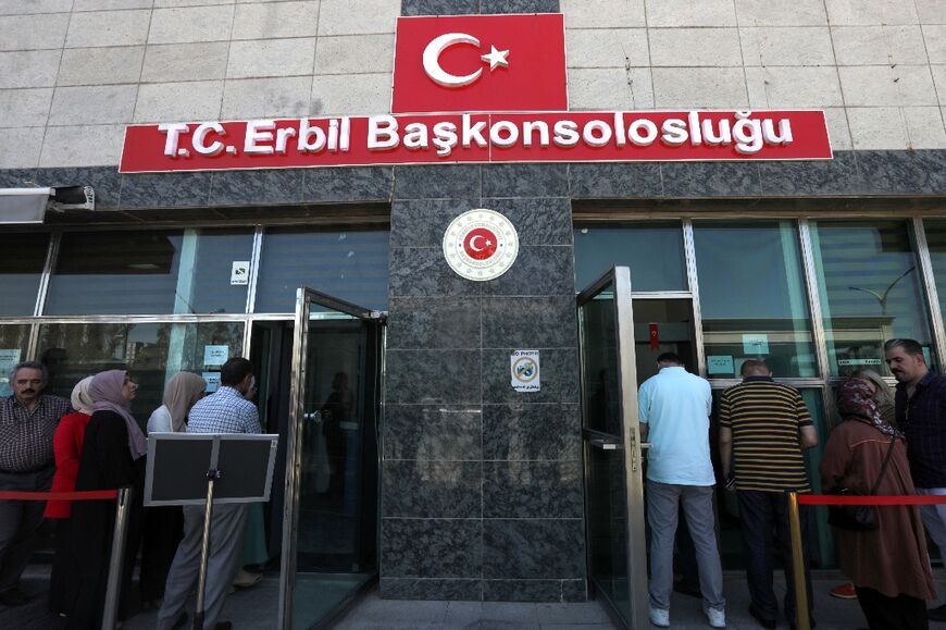 Turkish citizens in Arbil wait outside the Turkish embassy to vote ahead of Sunday's Turkish presidential election 
